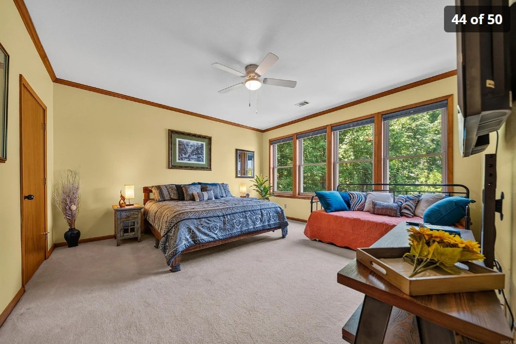 Lower level guest suite with warm tones, large windows, and sitting area