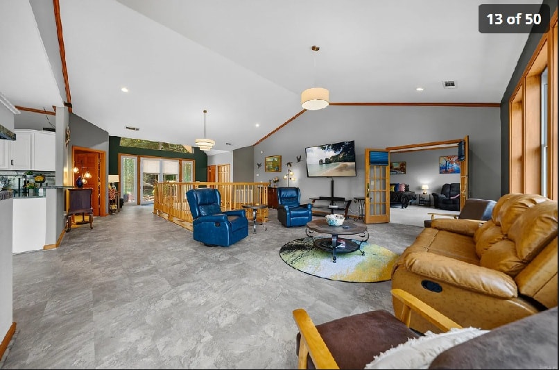 Great room with vaulted ceilings and French doors opening to the waterfront deck